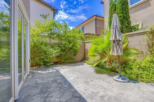 a view of a swimming pool with a lawn chairs under palm trees