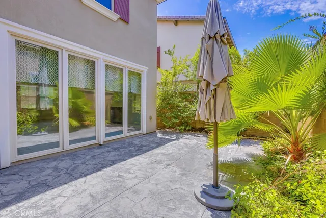 a view of a patio with swimming pool and furniture