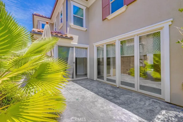 a view of a swimming pool with a patio and a yard