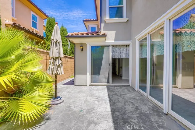 a view of a swimming pool with lawn chairs under an umbrella