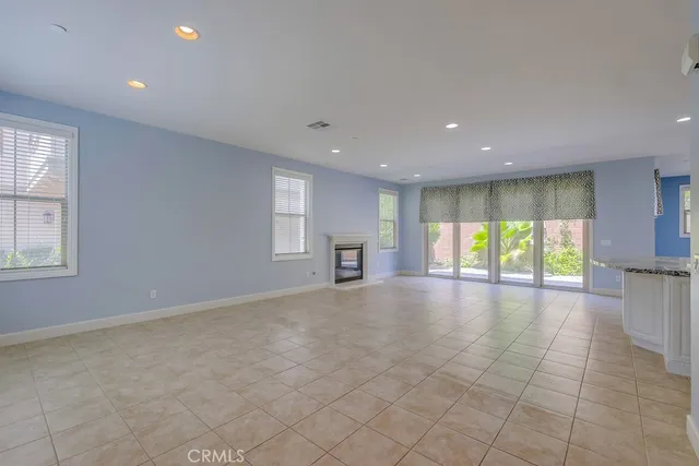 a view of kitchen with kitchen island a sink wooden floor and a refrigerator