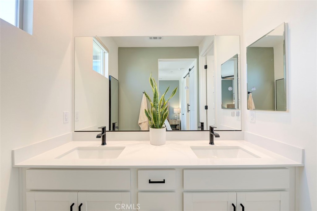 861 Cornelia Way Rancho Mission Viejo, CA 92694 - Photo 12 of 39 a bathroom with double vanity sinks and a mirror