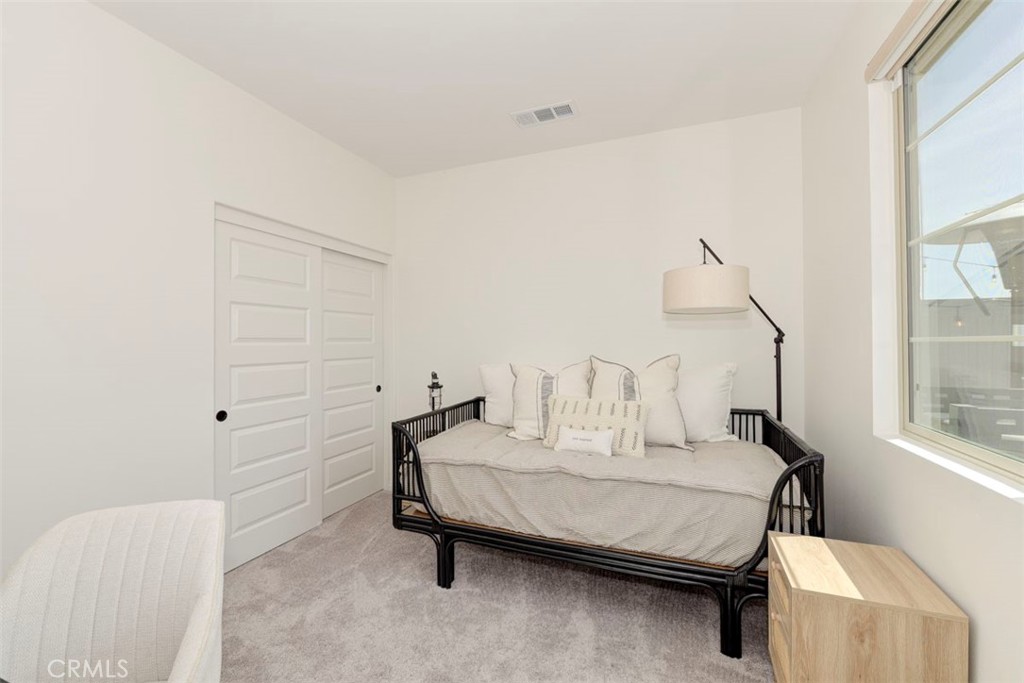 861 Cornelia Way Rancho Mission Viejo, CA 92694 - Photo 17 of 39 a bedroom with a bed and a table in it