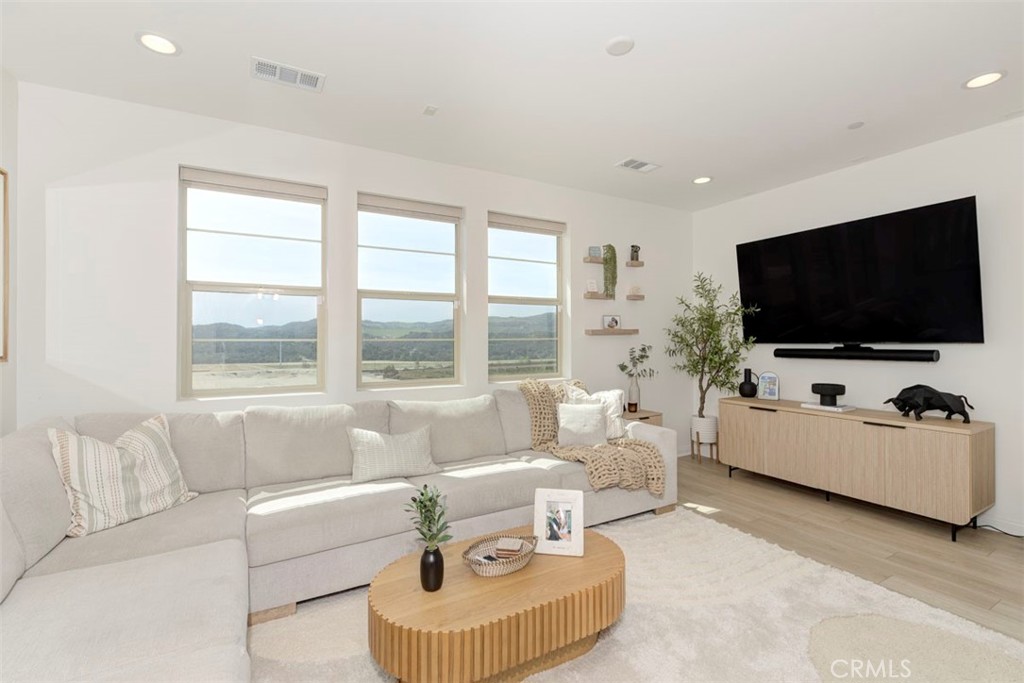 861 Cornelia Way Rancho Mission Viejo, CA 92694 - Photo 5 of 39 a living room with furniture and a flat screen tv