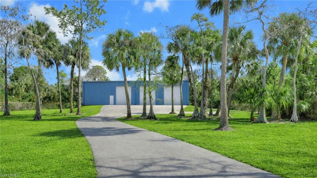 730 29th Street Southwest Naples, FL 34117 - Photo 5 of 50 Virtually Staged Surrounding community with an outbuilding and driveway
