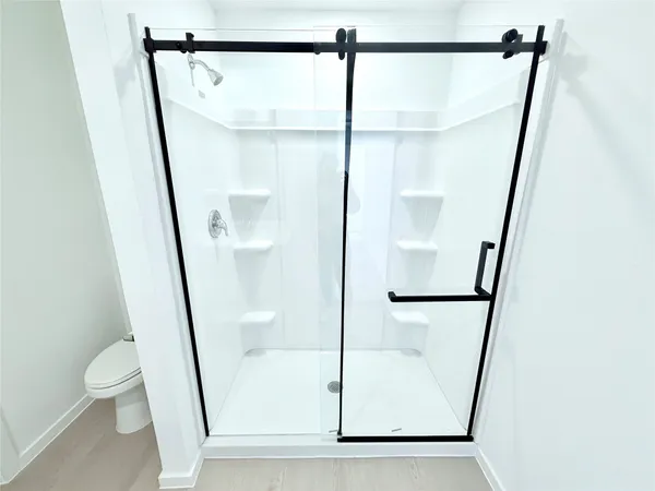 a bathroom with a glass door shower