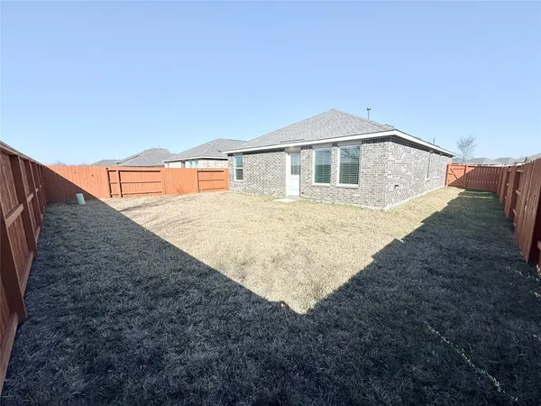 a house view with a backyard space