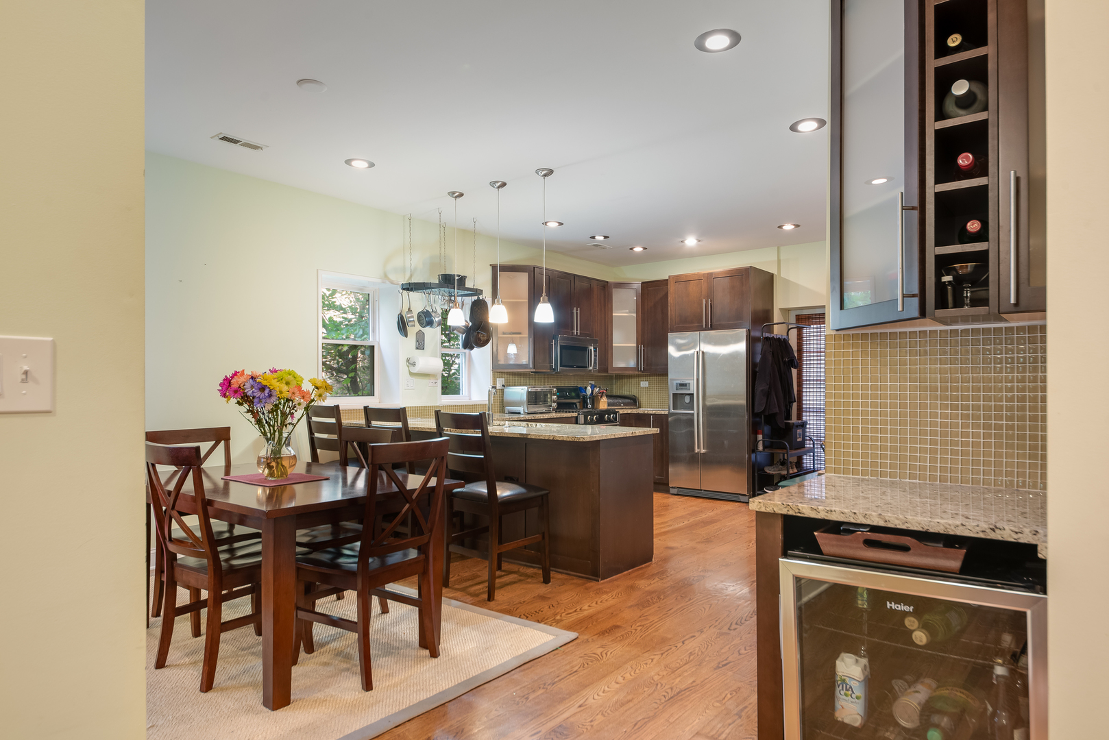 6967 North Sheridan Road, Unit 1 Chicago, IL 60626 - Photo 13 of 21 a kitchen with stainless steel appliances kitchen island granite countertop a table and chairs in it