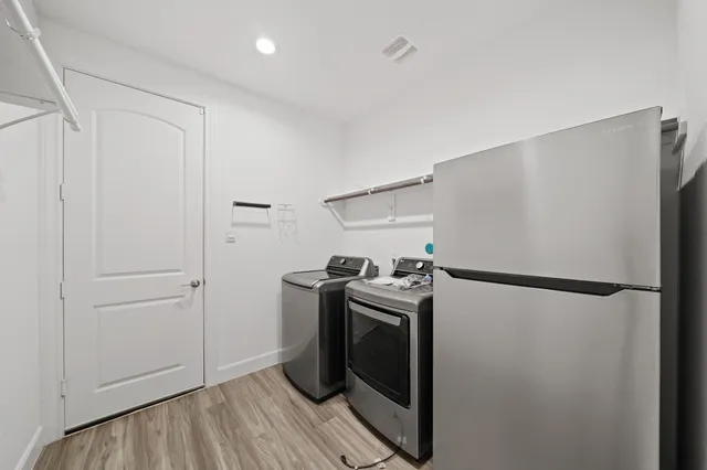 a kitchen with a refrigerator and a stove
