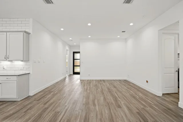 a view of a kitchen with wooden floor and a sink