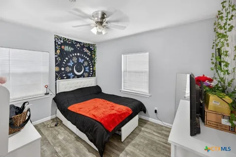a room with pool table and potted plants
