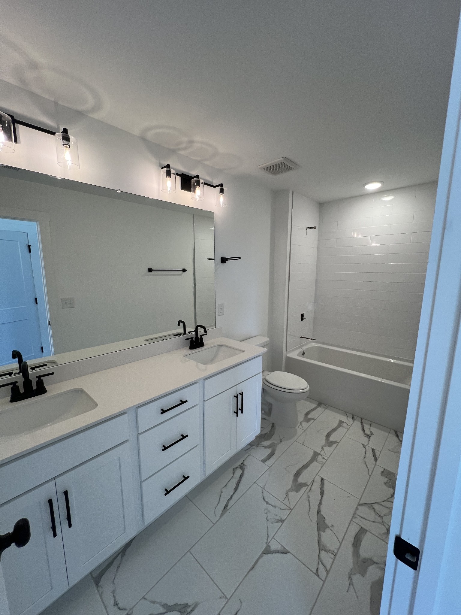 304 Strong Street Columbia, TN 38401 - Photo 16 of 49 a spacious bathroom with double sink a toilet a shower and a mirror