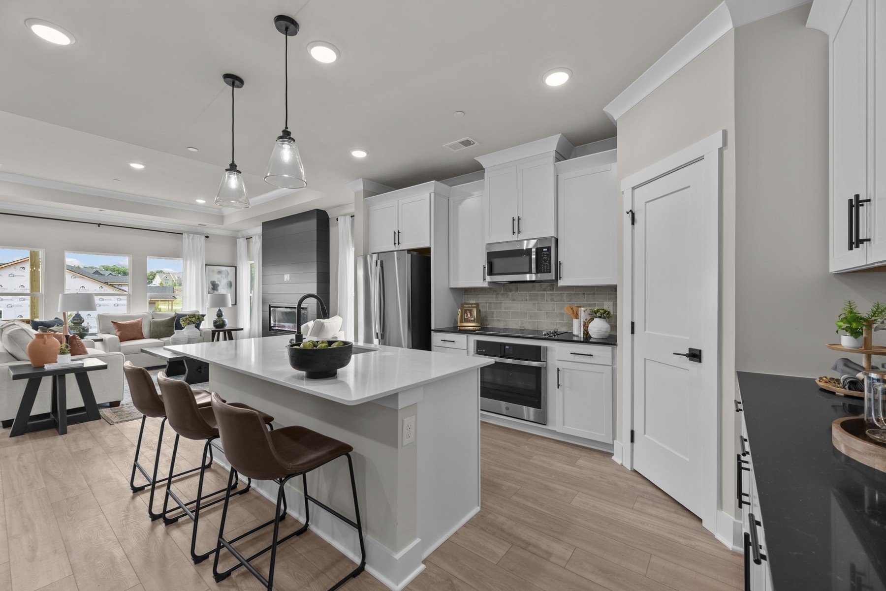 304 Strong Street Columbia, TN 38401 - Photo 22 of 49 a kitchen with stainless steel appliances kitchen island granite countertop a refrigerator a stove a sink a dining table and chairs with wooden floor