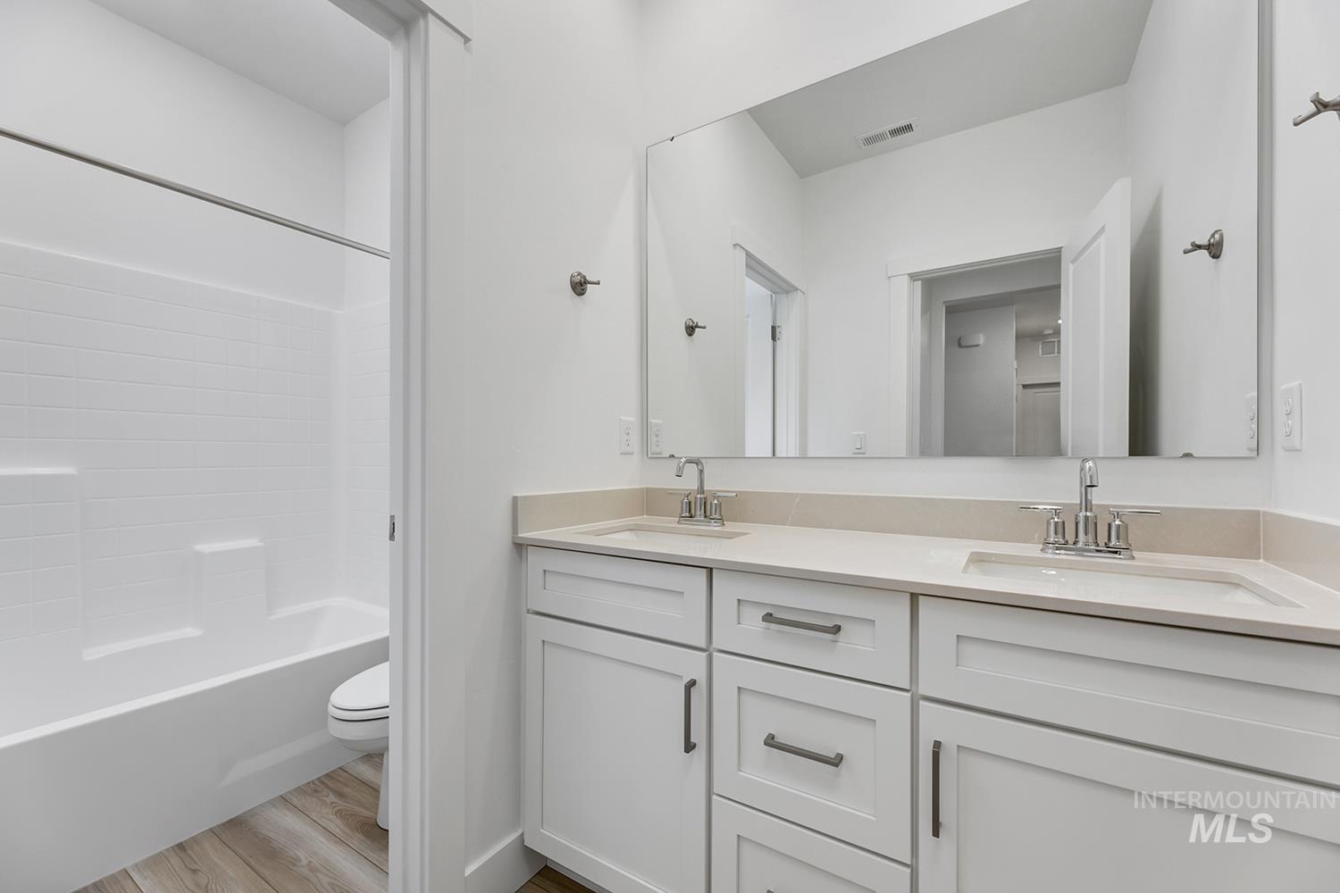 4548 West Wapoot Street Meridian, ID 83646 - Photo 17 of 17 Dual vanity with undermount sinks, light-toned countertops, and brushed nickel fixtures