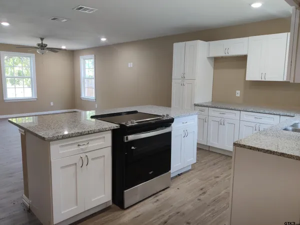 a kitchen with a sink stove and cabinets