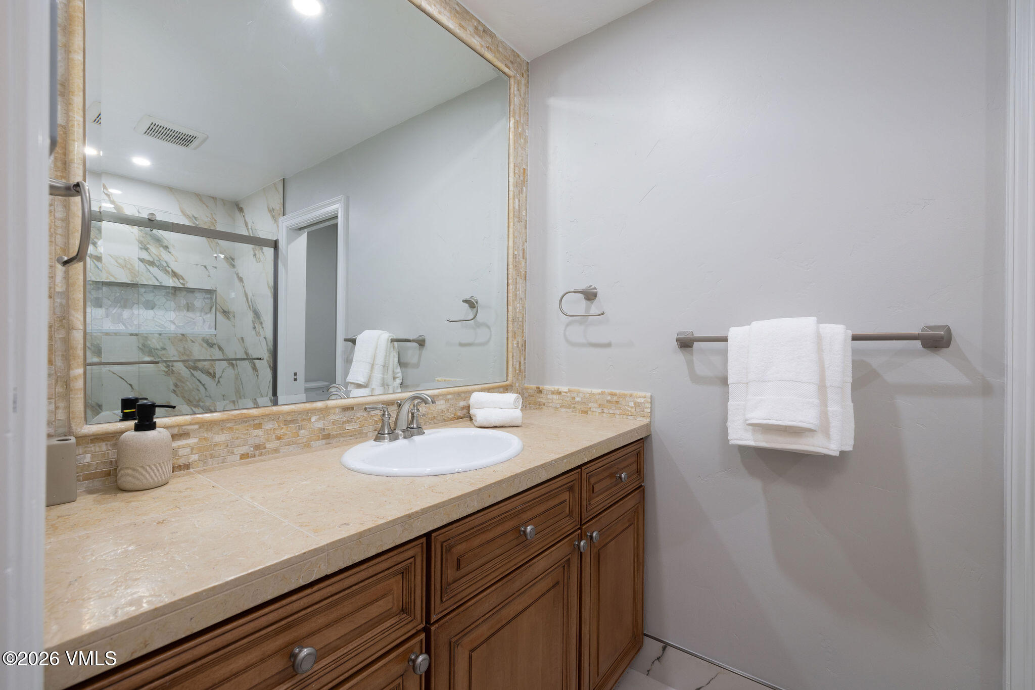 99 Castle Peak Close, Unit B Edwards, CO 81632 - Photo 15 of 35 a bathroom with a granite countertop sink a mirror and vanity