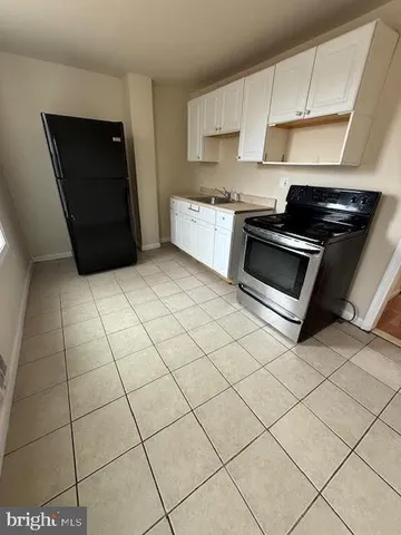 a kitchen with stainless steel appliances a sink and cabinets