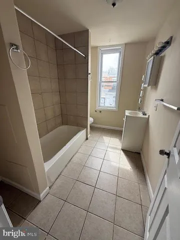 a bathroom with a bathtub and toilet