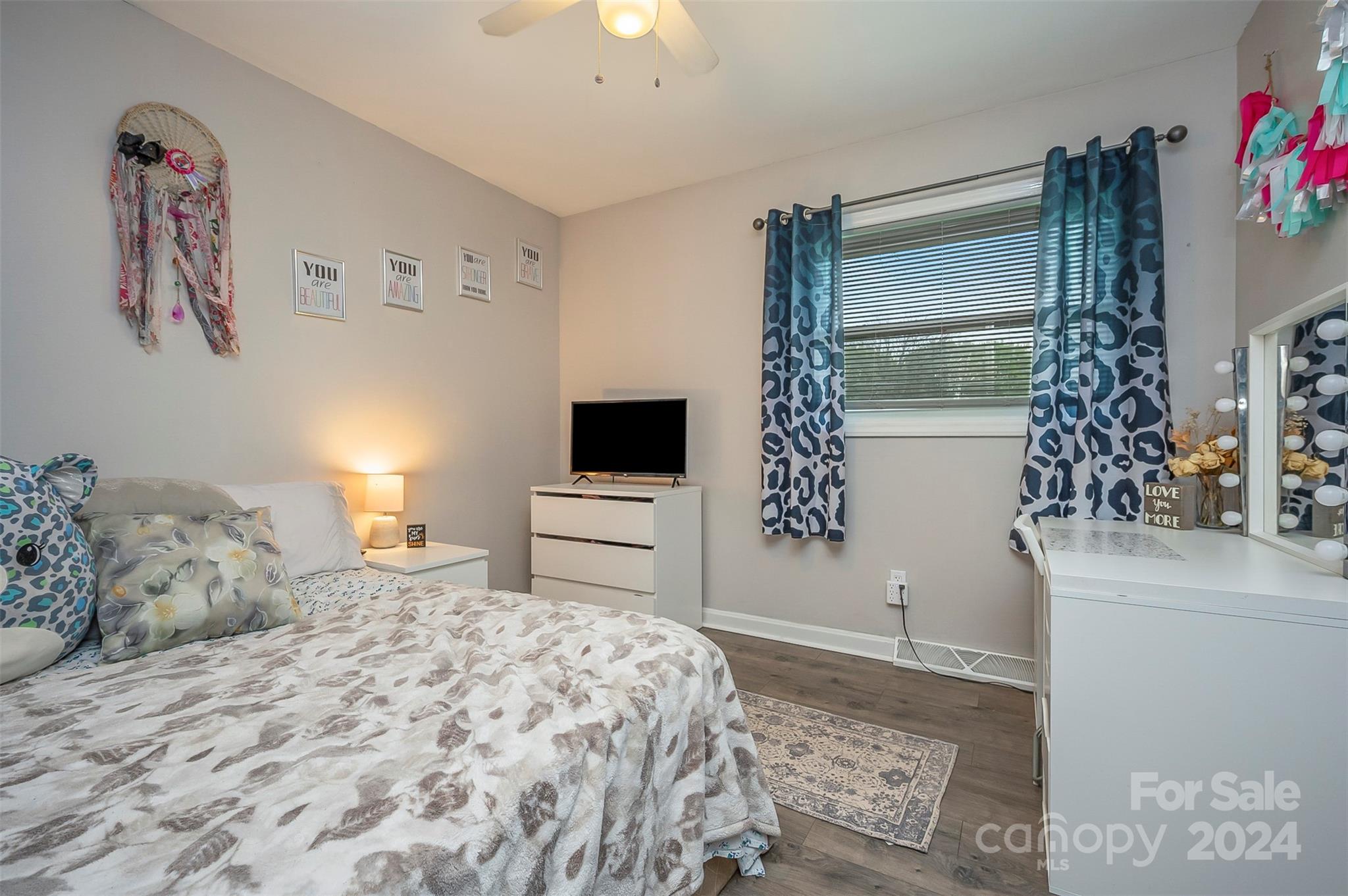 207 Smith Grove Road Forest City, NC 28043 - Photo 13 of 37 a bedroom with a bed and a chandelier