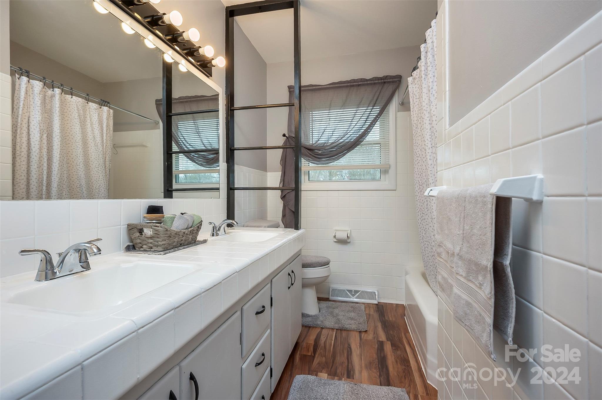 207 Smith Grove Road Forest City, NC 28043 - Photo 14 of 37 a bathroom with a sink a toilet a mirror and shower