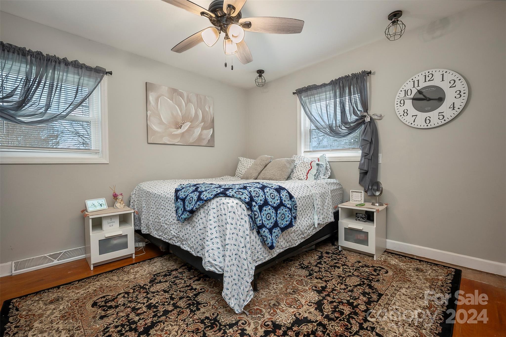 207 Smith Grove Road Forest City, NC 28043 - Photo 16 of 37 a bedroom with a bed and a chandelier