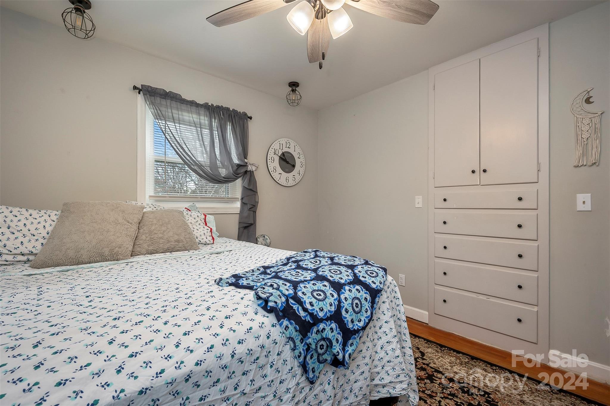 207 Smith Grove Road Forest City, NC 28043 - Photo 17 of 37 a bedroom with a bed and a chandelier