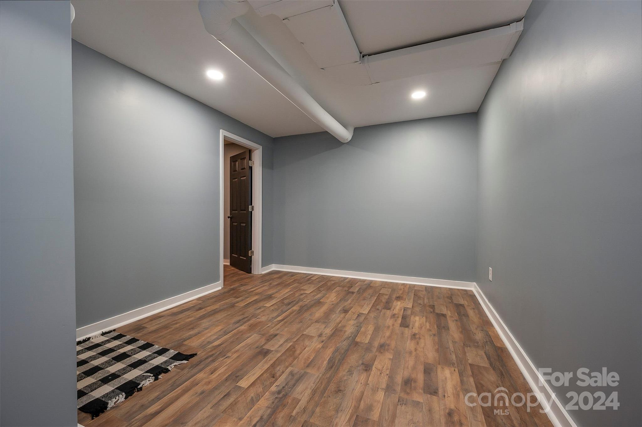 207 Smith Grove Road Forest City, NC 28043 - Photo 20 of 37 an empty room with wooden floor and windows