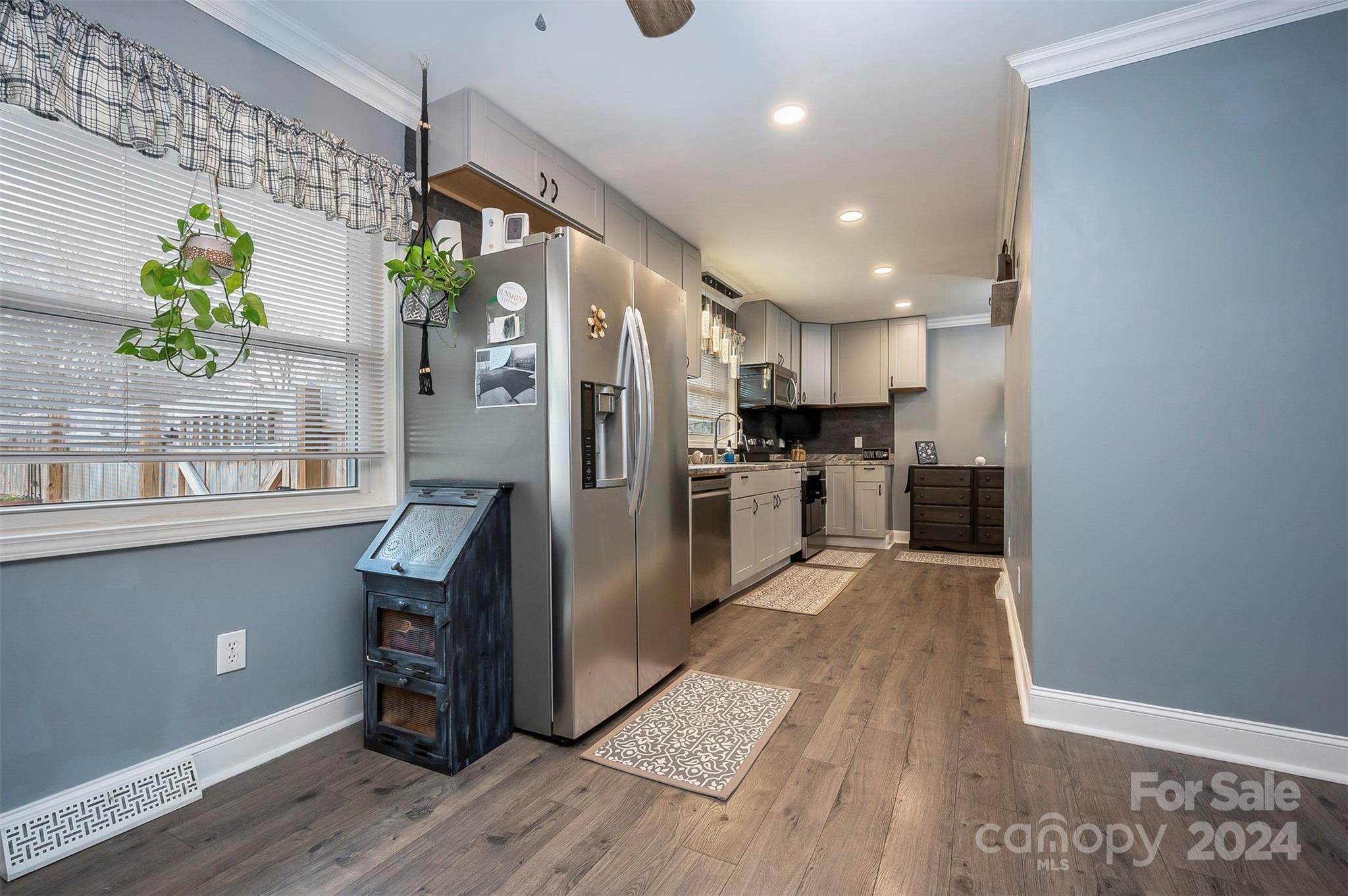 207 Smith Grove Road Forest City, NC 28043 - Photo 8 of 37 a kitchen with stainless steel appliances granite countertop a refrigerator a stove and a wooden floors