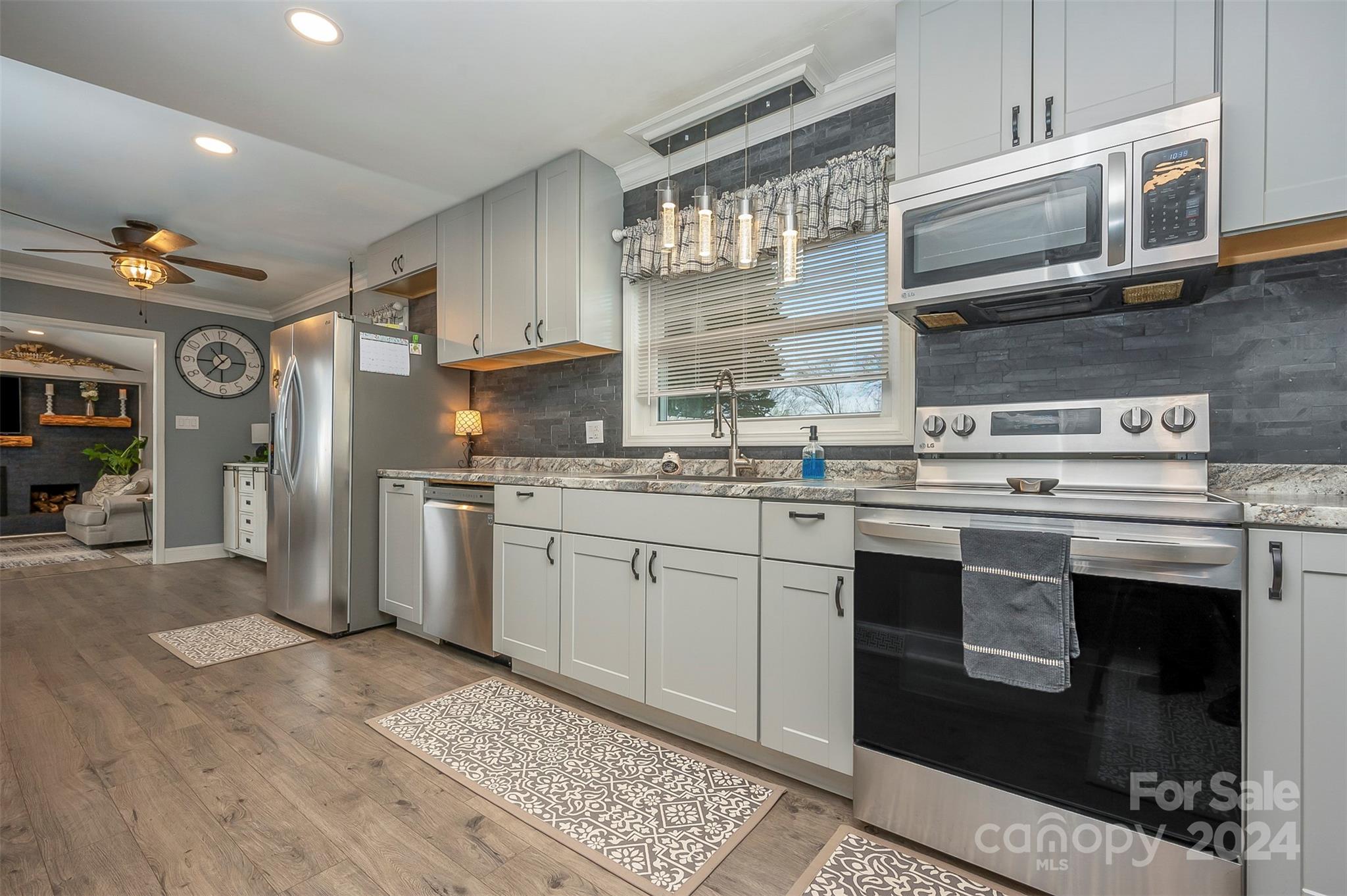 207 Smith Grove Road Forest City, NC 28043 - Photo 10 of 37 a kitchen with stainless steel appliances granite countertop a stove a sink and a microwave