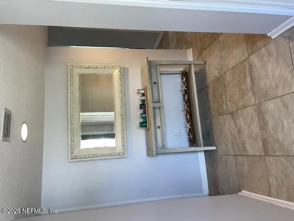 a view of walk in closet with clothes