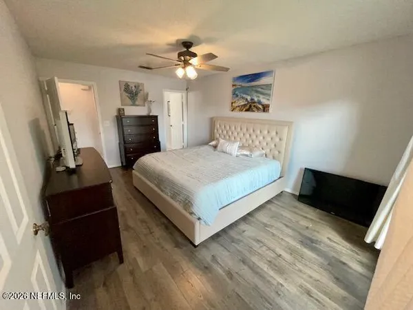 a bedroom with a bed and a large mirror