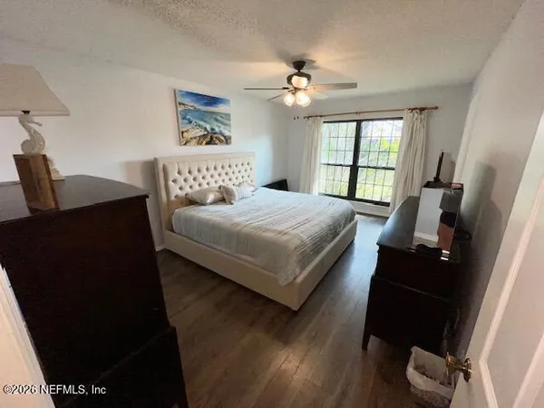 a front view of house with yard and trees in the background