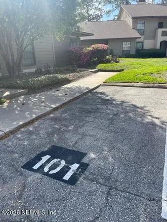 a sign that is sitting in the grass next to a road
