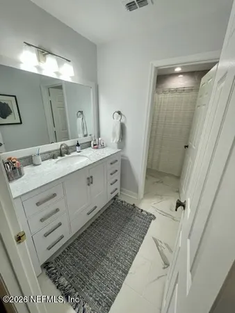 a bathroom with a double vanity sink and mirror