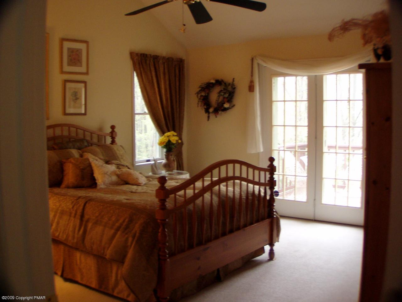 Devil's Hole Road Cresco, PA 18326 - Photo 13 of 27 a bed sitting in a bedroom next to a window