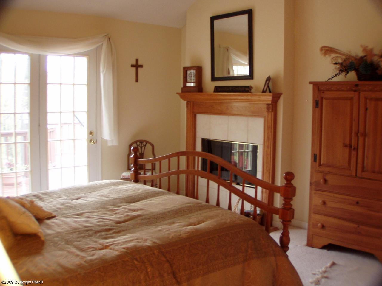 Devil's Hole Road Cresco, PA 18326 - Photo 14 of 27 a bedroom with a bed and a flat tv screen on dresser