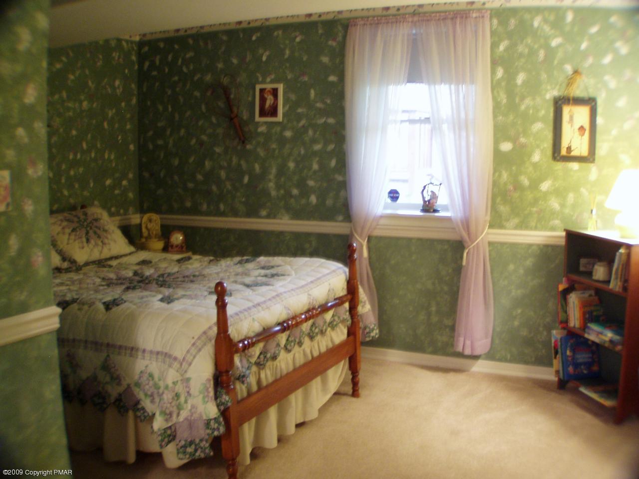 Devil's Hole Road Cresco, PA 18326 - Photo 20 of 27 a bed sitting in a bedroom next to a window