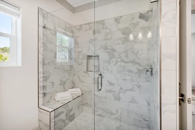 a bathroom with a granite countertop sink a toilet a large mirror a shower and bathtub