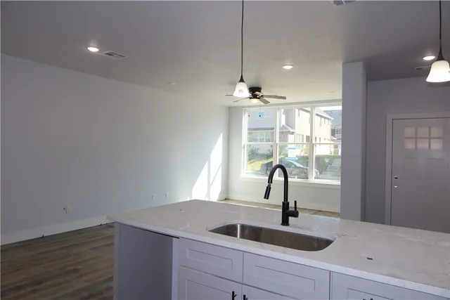 a kitchen with a sink and chandelier