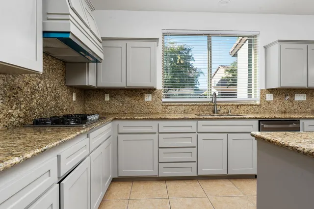 a kitchen with stainless steel appliances granite countertop a stove and a microwave