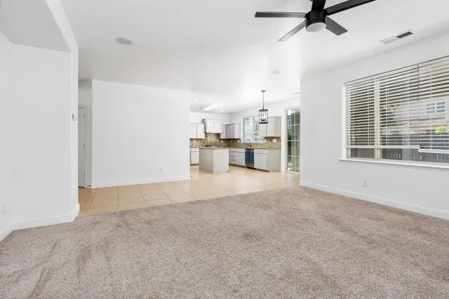 a view of a kitchen with a sink and a refrigerator