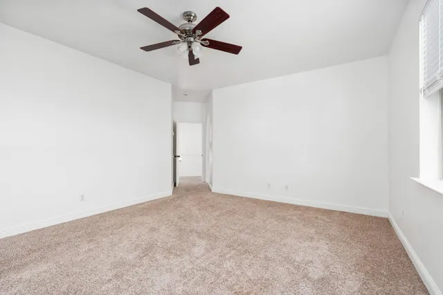 a spacious bathroom with a granite countertop sink and a mirror