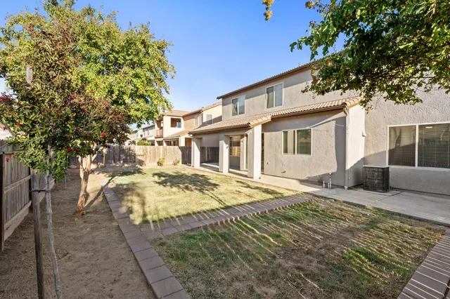 a view of small yard and wooden fence