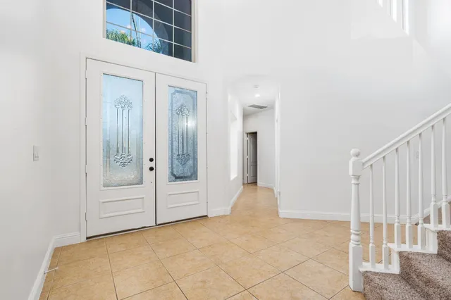 a view of a hallway with entryway door