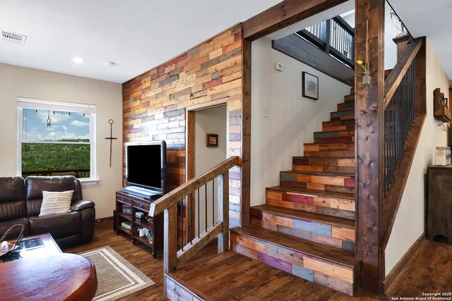 a living room with furniture and flat screen tv