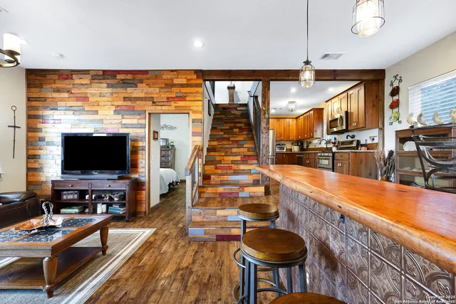 a living room with furniture a flat screen tv and a window