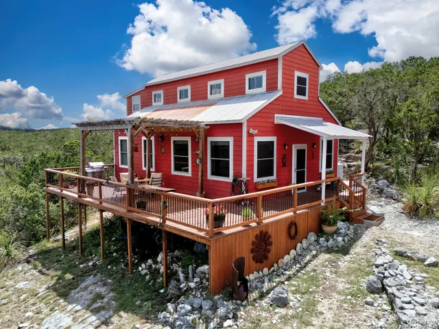 a view of a house with a yard and sitting area