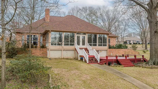 a view of a house with backyard porch and sitting area