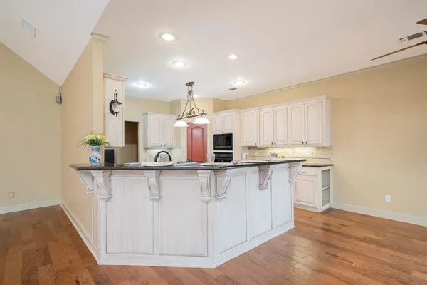 a kitchen with stainless steel appliances a sink and cabinets