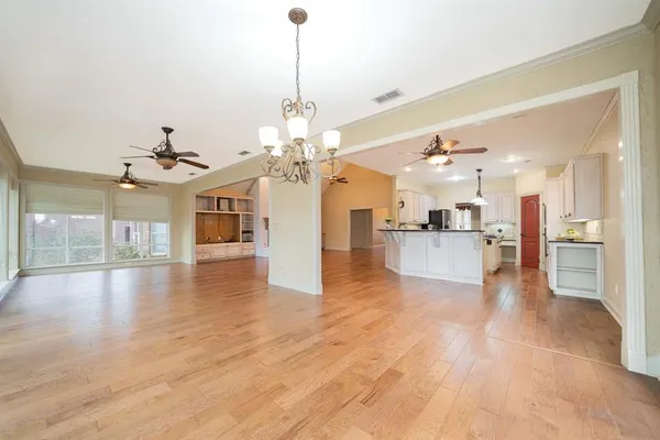 a view of a kitchen with a sink dishwasher a kitchen view and a chandelier